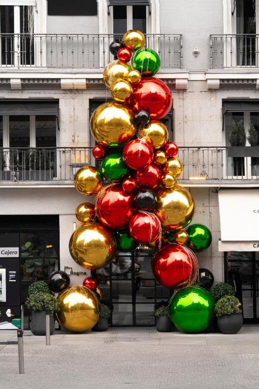 a christmas tree in front of a building at Hotel Regina in Madrid
