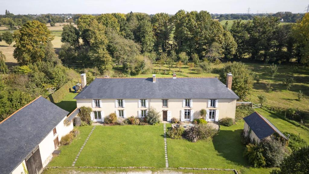 an aerial view of a large white house with a yard at Le Grand Launay in Pacé