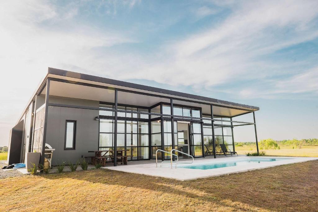 a house with a swimming pool in front of it at Carmelo Golf by Puerto Dijama in Colonia Estrella
