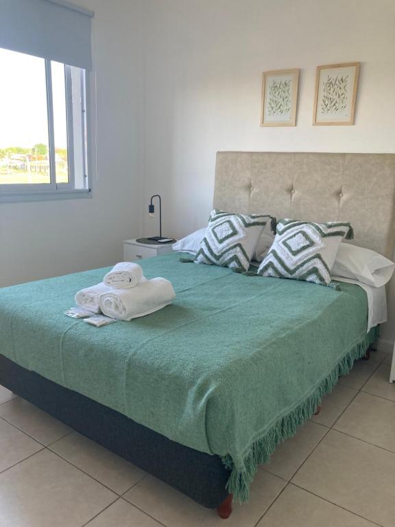 a bedroom with a bed with towels on it at Como en casa in Concepción del Uruguay