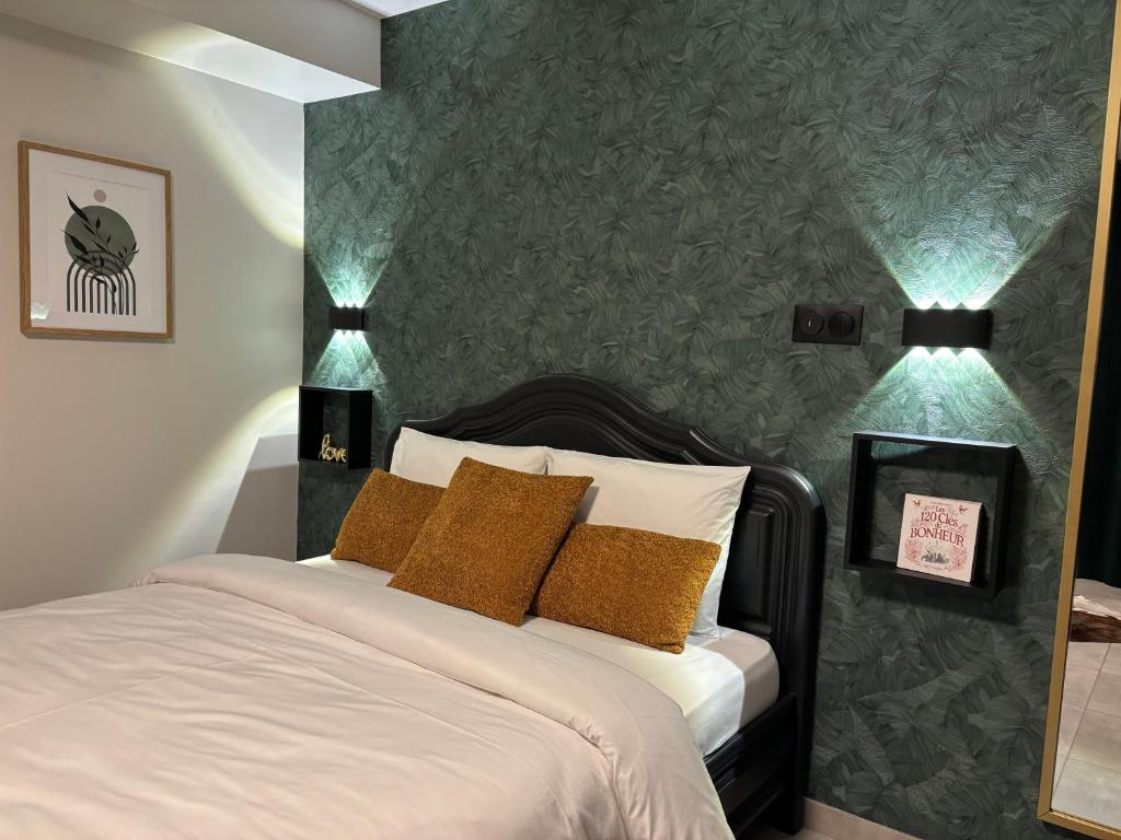 a bedroom with a white bed with two pillows at Élégant 2 pièces au calme, axe Metz-Luxembourg in La Celle-sous-Gouzon