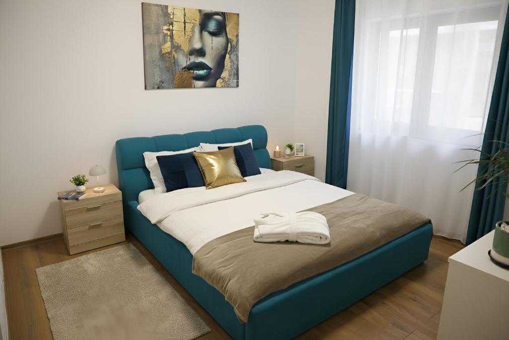 een bed met een blauw hoofdeinde in een slaapkamer bij Hushu Apartment in Giroc