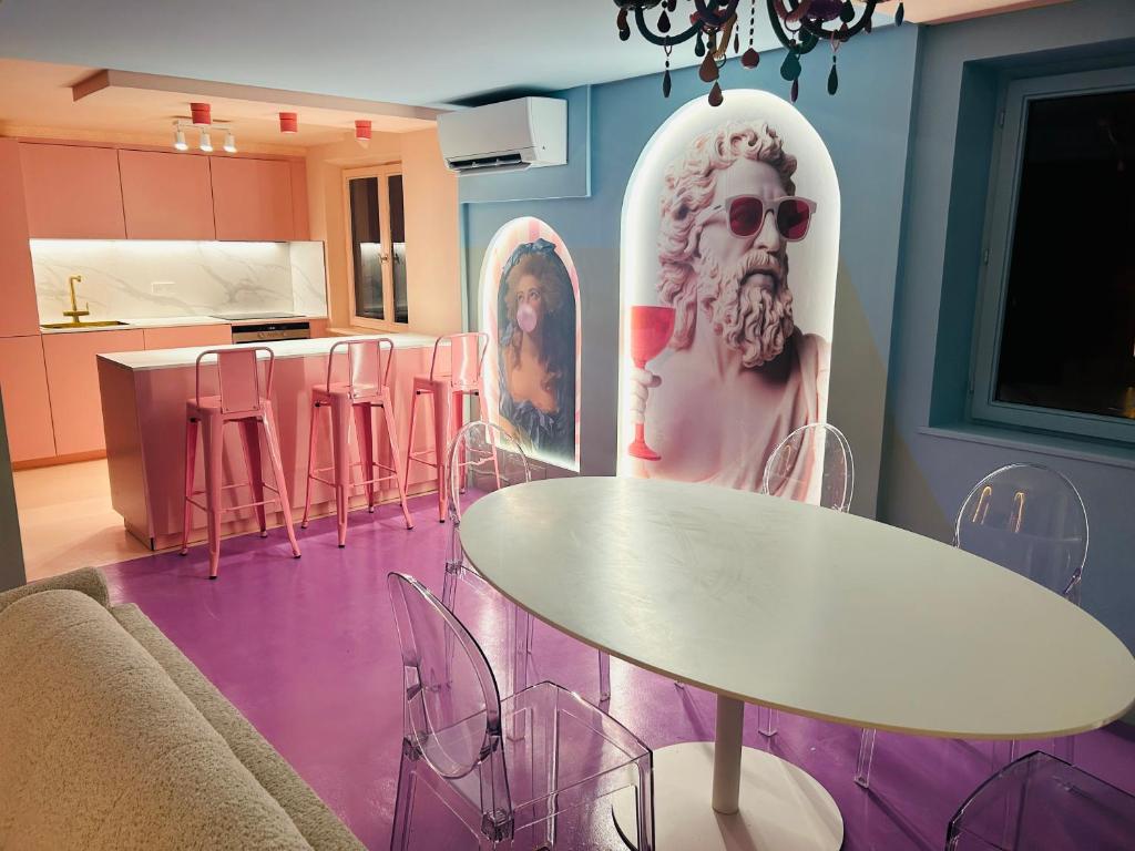 a room with a table and a picture of a woman at Villa Signature in Oberhausbergen