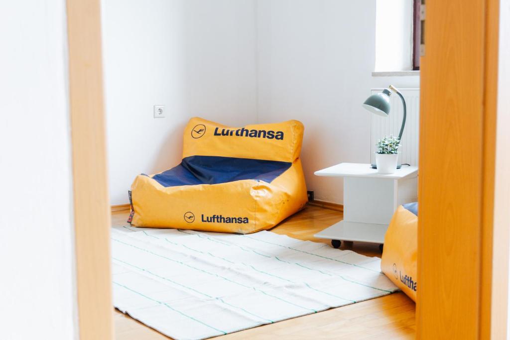 a room with a yellow bed in the corner of a room at raum life - Ferienwohnung Straubing #1 in Straubing