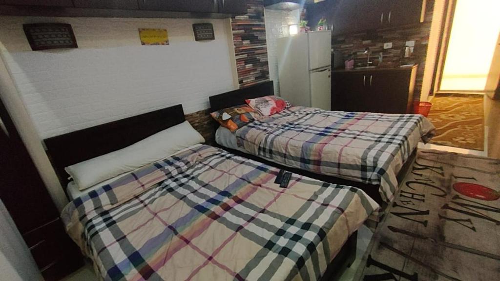 two beds sitting next to each other in a room at cecelia resort in Hurghada