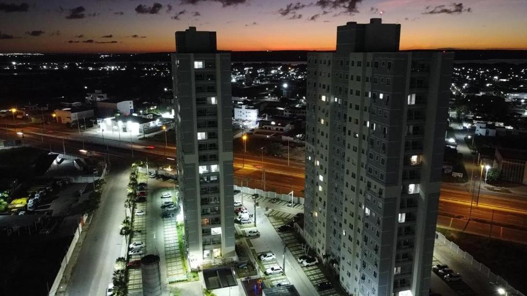 a view of a city at night with buildings at (208)Apt de luxo com varanda 2 quartos 1km do Mar in Tambauzinho