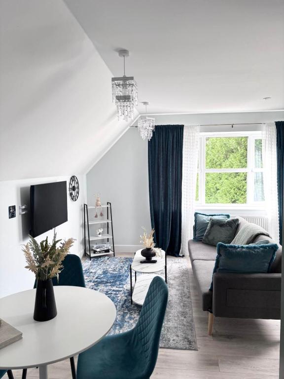 a living room with a couch and a table at Castle-View Apartment & Free Parking on Site in Dover