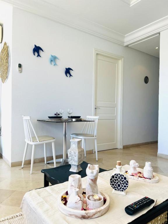 a living room with a table with food on it at Maison Douceur in Dar el Ouzir