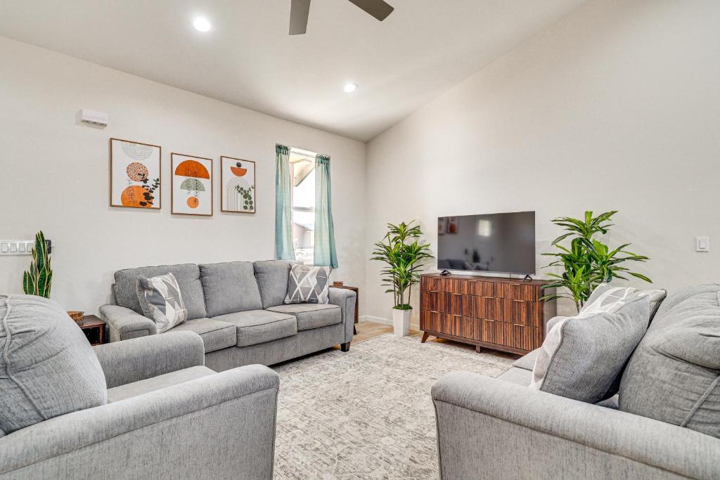 a living room with two couches and a flat screen tv at Hike and Ski! Home with Dog-Friendly Yard in Eagar in Eagar