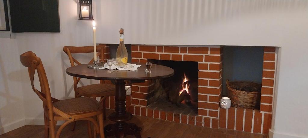 a fireplace with a table and a fire place at Cantinho de Terena - Cheiros Da Terra in Terena