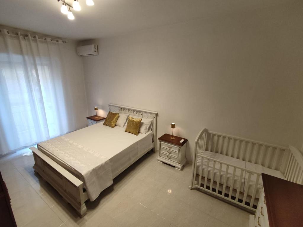 a bedroom with a bed and a crib in it at HOME SWEET HOME Casa vacanze e affitti brevi in Trani