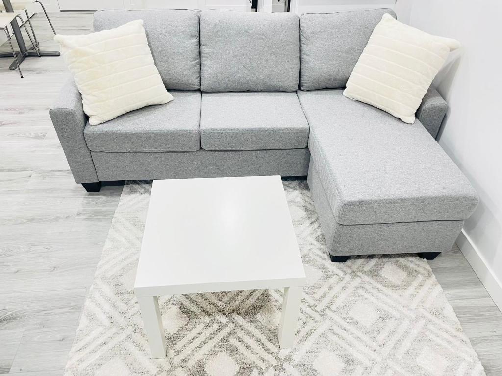 a living room with a couch and a white coffee table at Ivey Homes in Edmonton