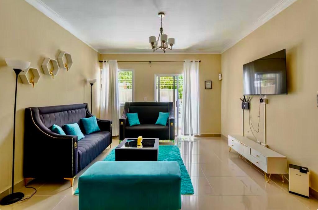 a living room with a couch and a table at Sky Blue in Jarabacoa