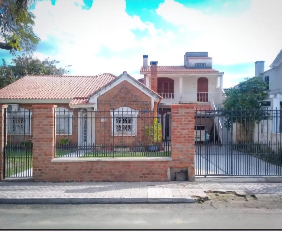 a house with a wrought iron fence at Pousada casa dos sonhos in São Gabriel