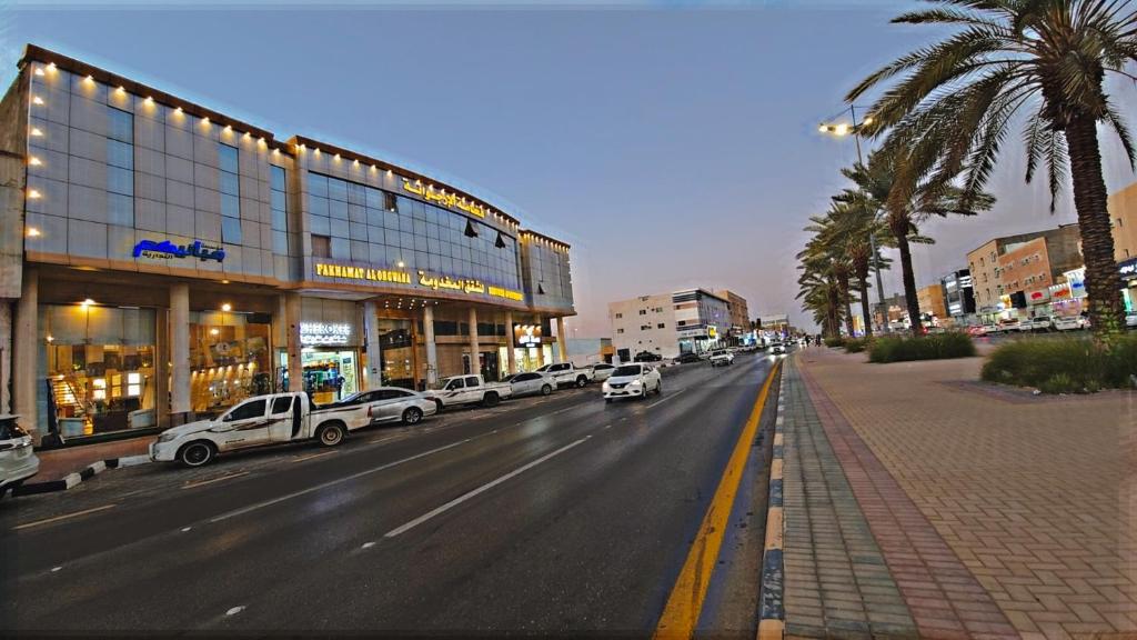 a city street with cars parked in front of a building at فخامه الارجوانه للشقق المخدومة in Sakakah