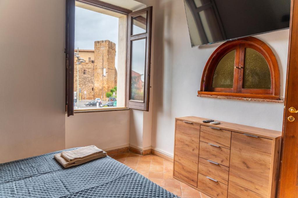 a bedroom with a bed and a window at Da Mario - Mondo Antico experience in Cerveteri