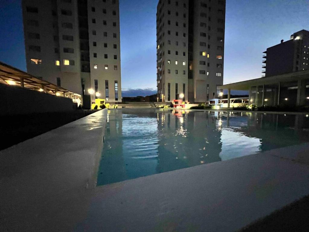 ein großes Schwimmbad in einer Stadt in der Nacht in der Unterkunft Torres Al Mar in Monte Hermoso