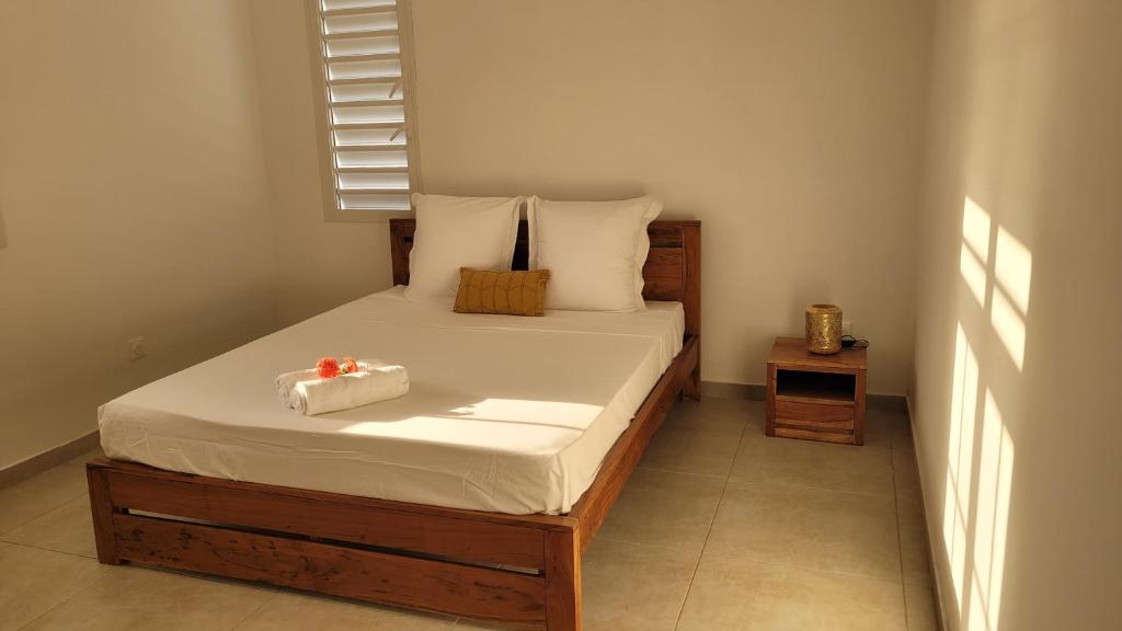 a bedroom with a bed with a box on it at Villa indigo Gp in Vieux-Habitants