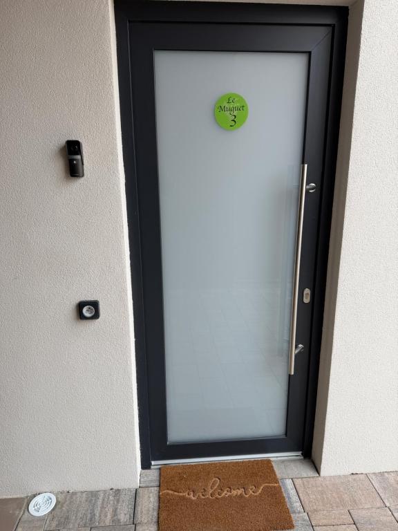 a glass door with a sticker on it at Maison MUGUET 3 SPA-PARKING-COLMAR in Wickerschwihr