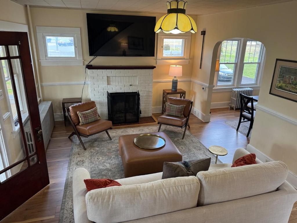a living room with a couch and a fireplace at Welcome to Duck Run in Mackeyville, Pennsylvania! in Mill Hall