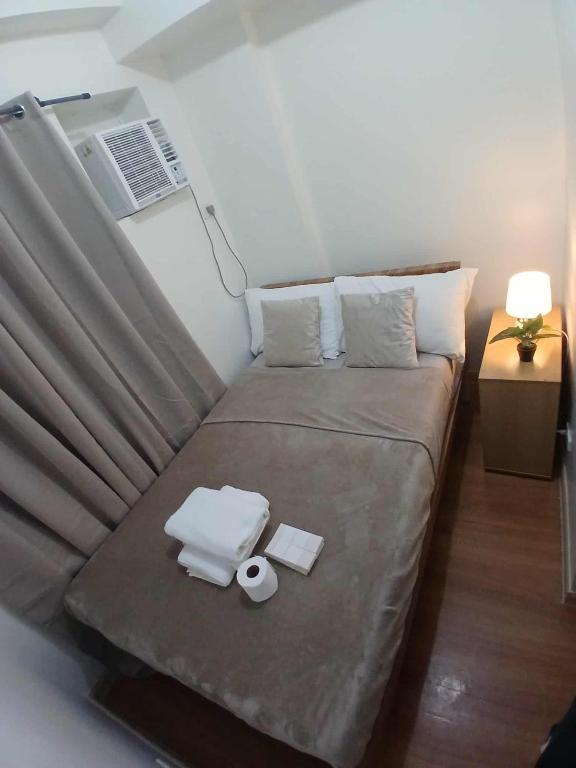 a bed in a small room with at camella northpoint condominium close to airport,sm lanang,abreeza mall,spmc,dmsf,usep in Davao City