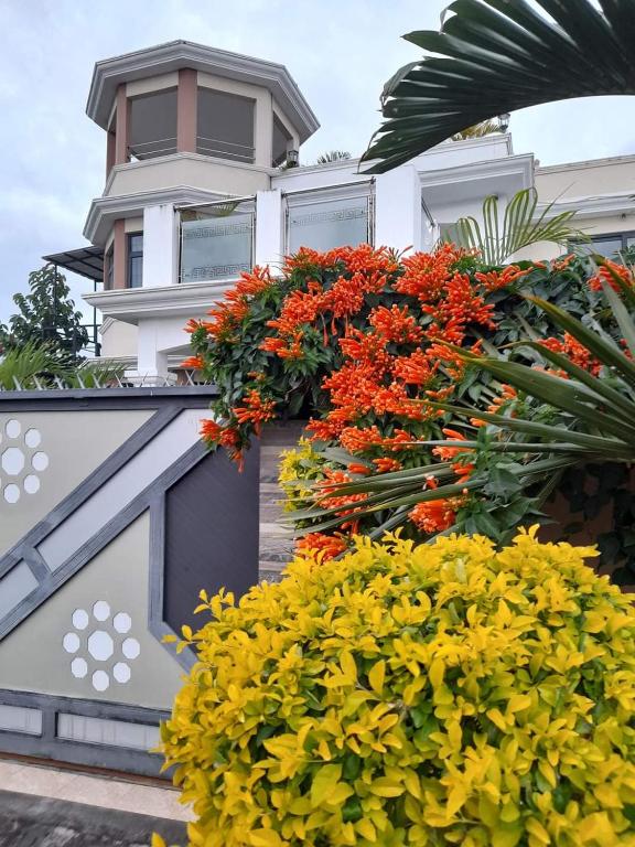 a building with flowers on the side of it at The Octagon wing A in Beau Vallon
