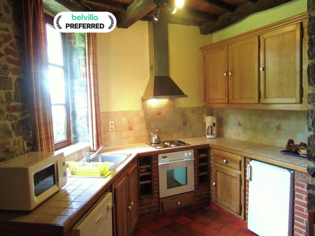 a kitchen with a sink and a stove at Alpine Getaway in Neustift in Treignes