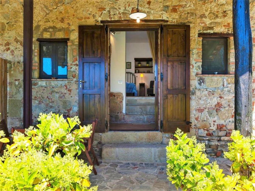 an open door to a stone building with plants at Villa in Velia near Roman Ruins and Beach in Marina di Ascea