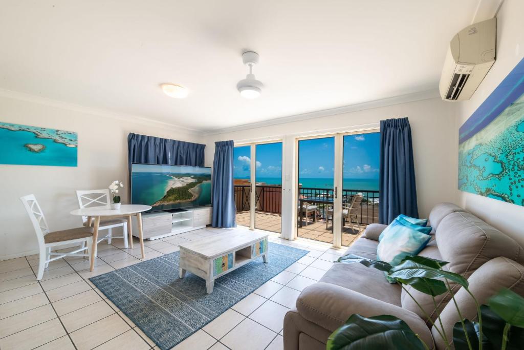 a living room with a couch and a table at Martinique Whitsunday Resort in Airlie Beach