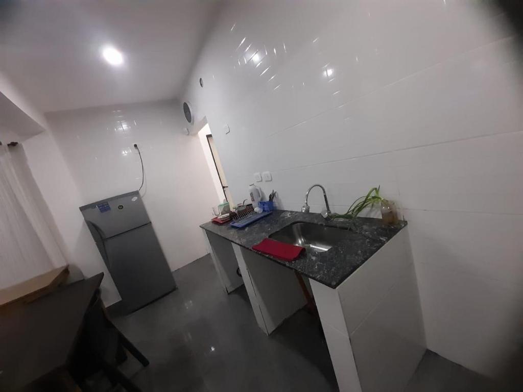 a white bathroom with a sink and a counter at Oceana Suites Elisio Mouriño in La Unión