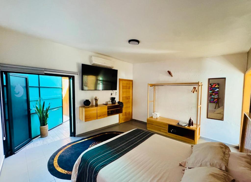 a bedroom with a large bed and a large mirror at Departamento en MossoCafe Oaxaca in Oaxaca City
