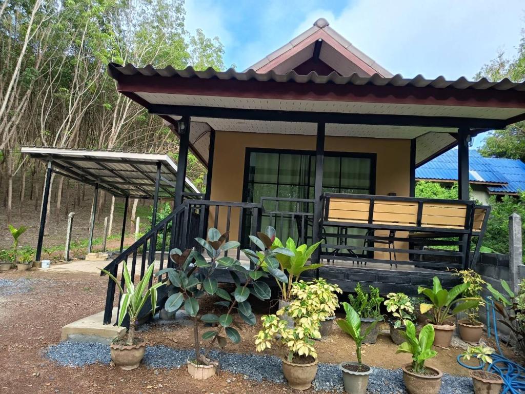 a small house with a bench in front of it at Lanta summer house nui bay in Ko Bu Bu