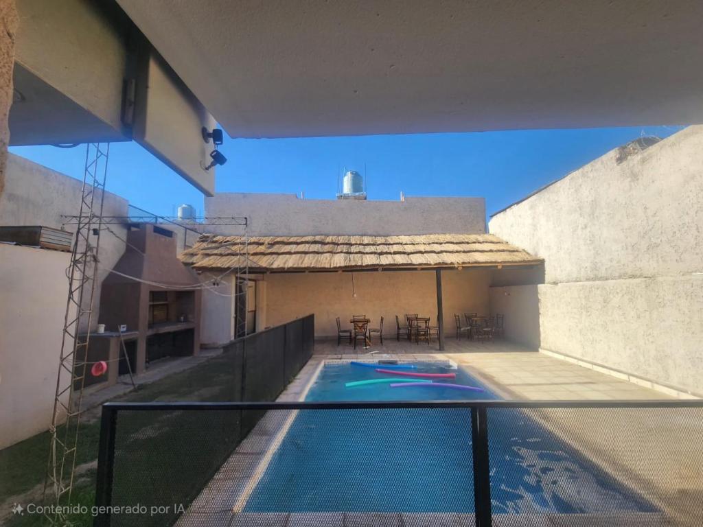 a swimming pool on the side of a building at alojamiento la pipi in Las Heras