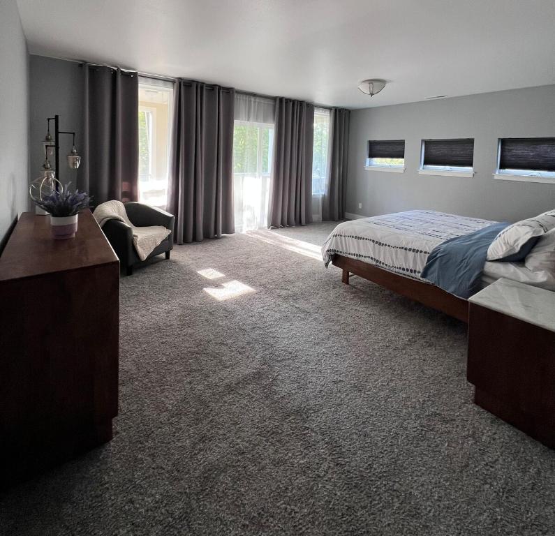 a bedroom with a bed and a chair in it at Cozy and stylish 3BR house in Tacoma