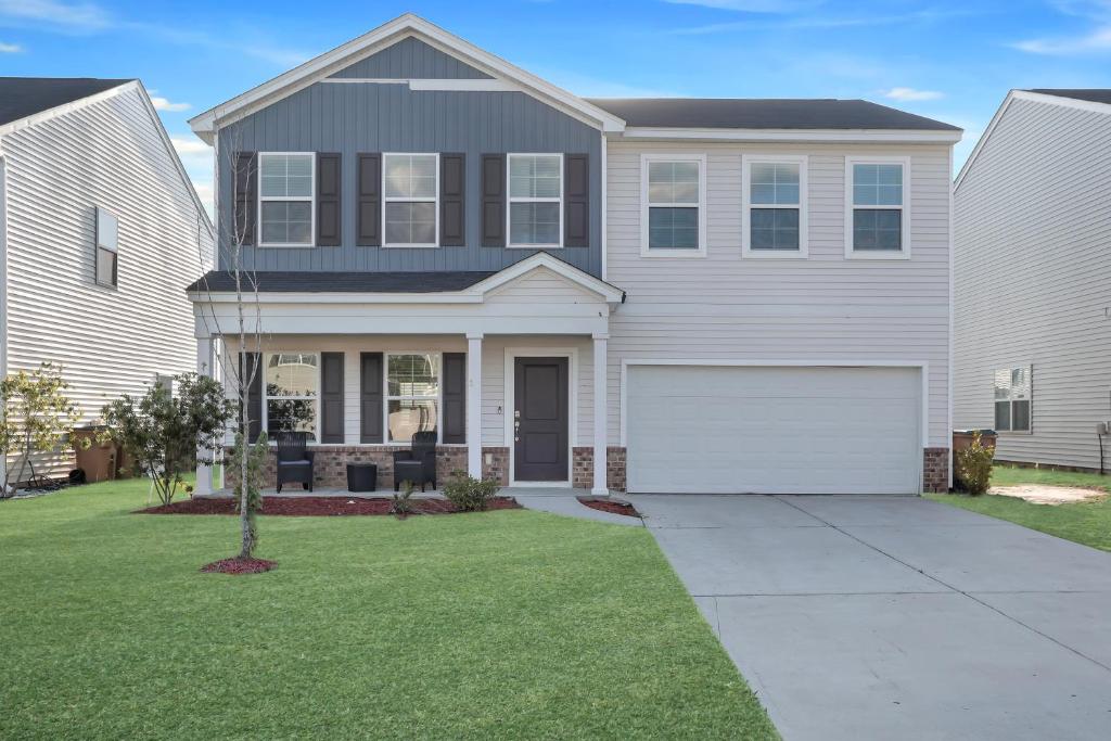 a large white house with a white garage at The Beautiful 31 in Port Wentworth