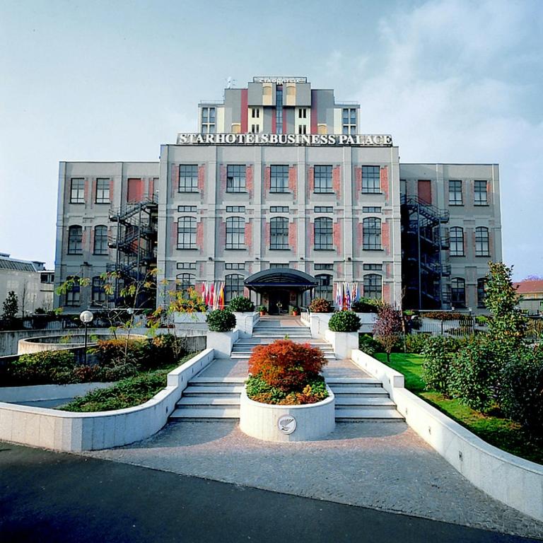 a large building with stairs in front of it at Starhotels Business Palace in Milan