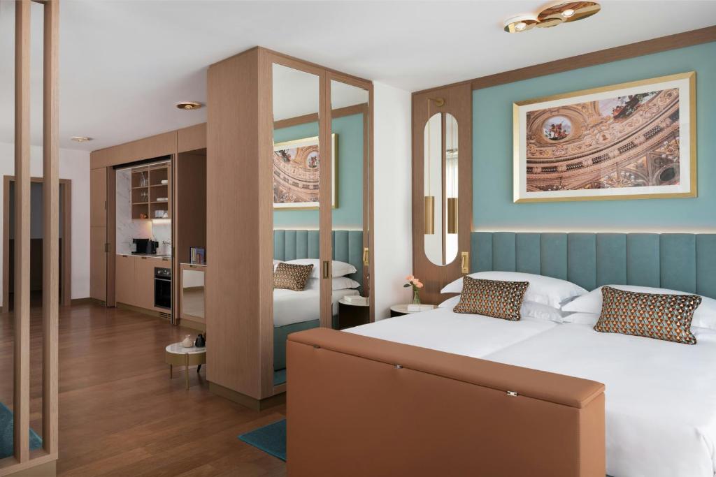 a bedroom with a large bed and a bathroom at Teatro Luxury Apartments Firenze - Starhotels Collezione in Florence
