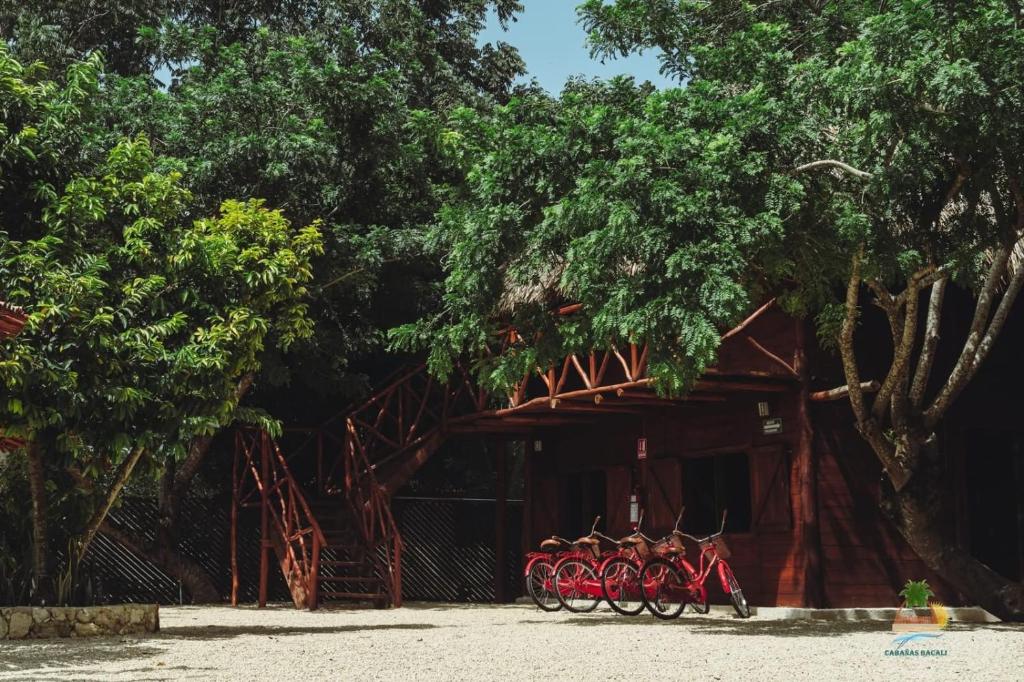a group of bikes parked in front of a building at Cabañas Bacali in Bacalar