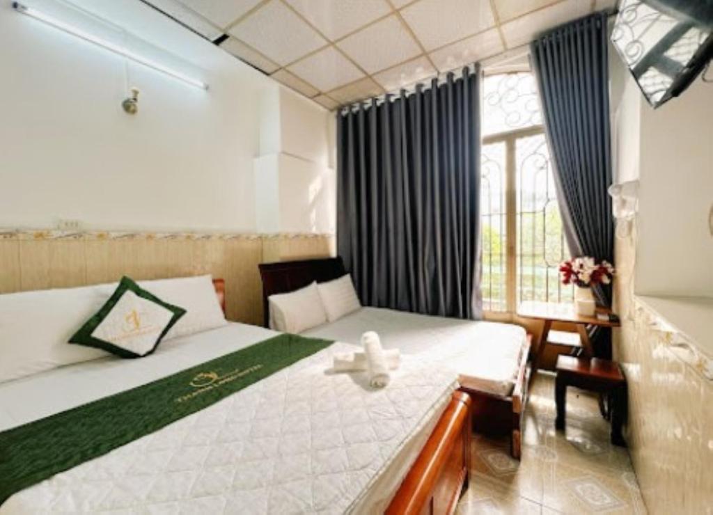 Postel nebo postele na pokoji v ubytování Thanh Long Hotel Hồ Chí Minh
