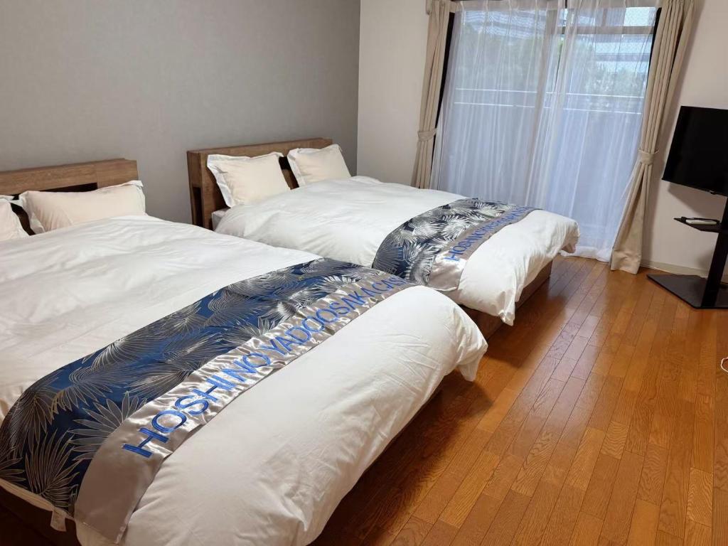 Postel nebo postele na pokoji v ubytování 星の宿大阪城