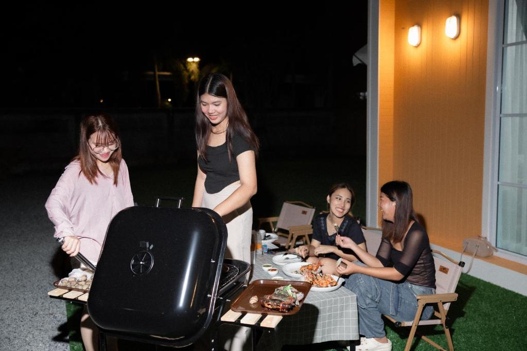 a group of women standing around a table with food at Waveway bangsaen 2 in Ban Thai Don (1)