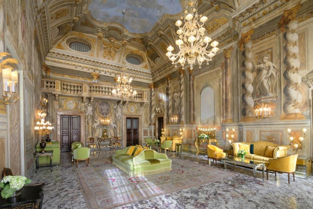 a large room with a chandelier and a building at Grand Hotel Continental Siena - Starhotels Collezione in Siena
