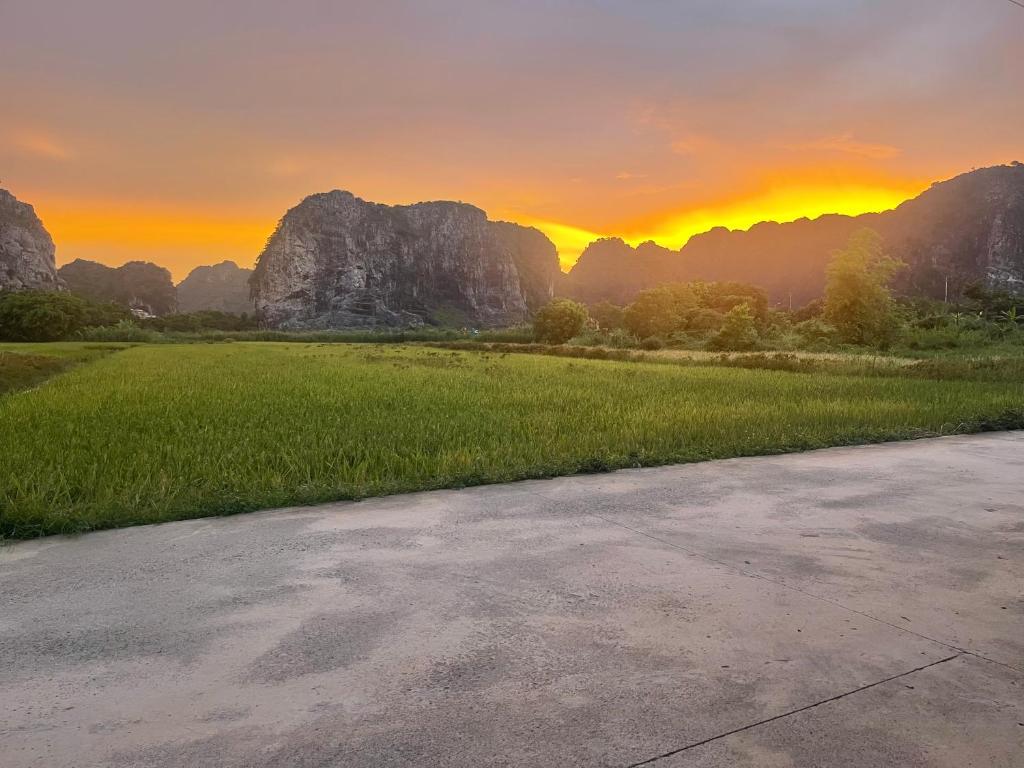 an empty road in front of mountains at sunset at Sol Flow Retreat in Nguyên Ngoại