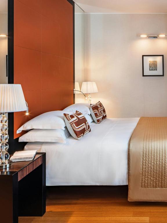 a hotel room with a bed with two pillows on it at Starhotels Anderson in Milan