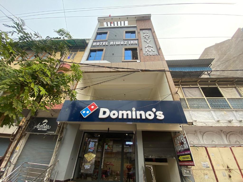 a store with a sign on the front of a building at Hotel O Riwaz Inn in Gwalior