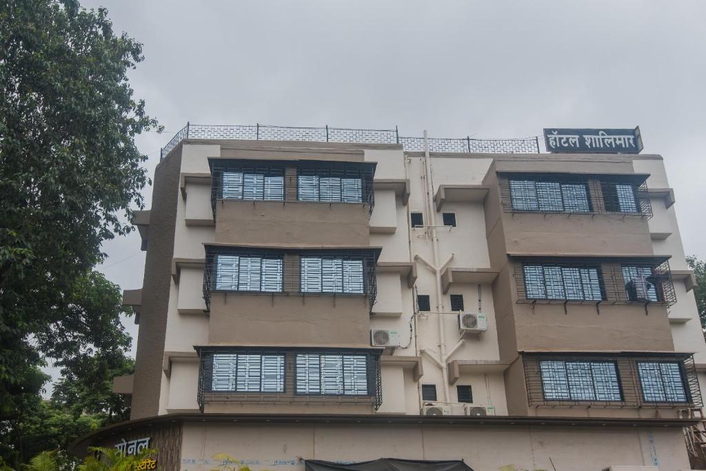 a tall building with windows on the side of it at Hotel O Shalimar in Mumbai