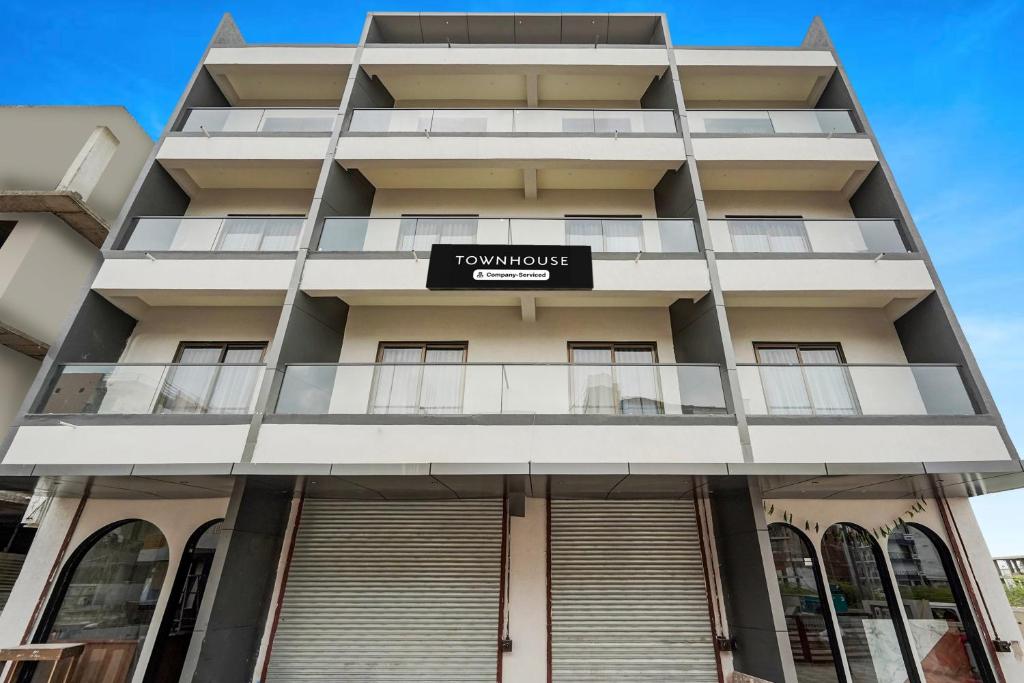 a building with a sign on the front of it at Super Townhouse GIDC Bol Sanand in Ahmedabad