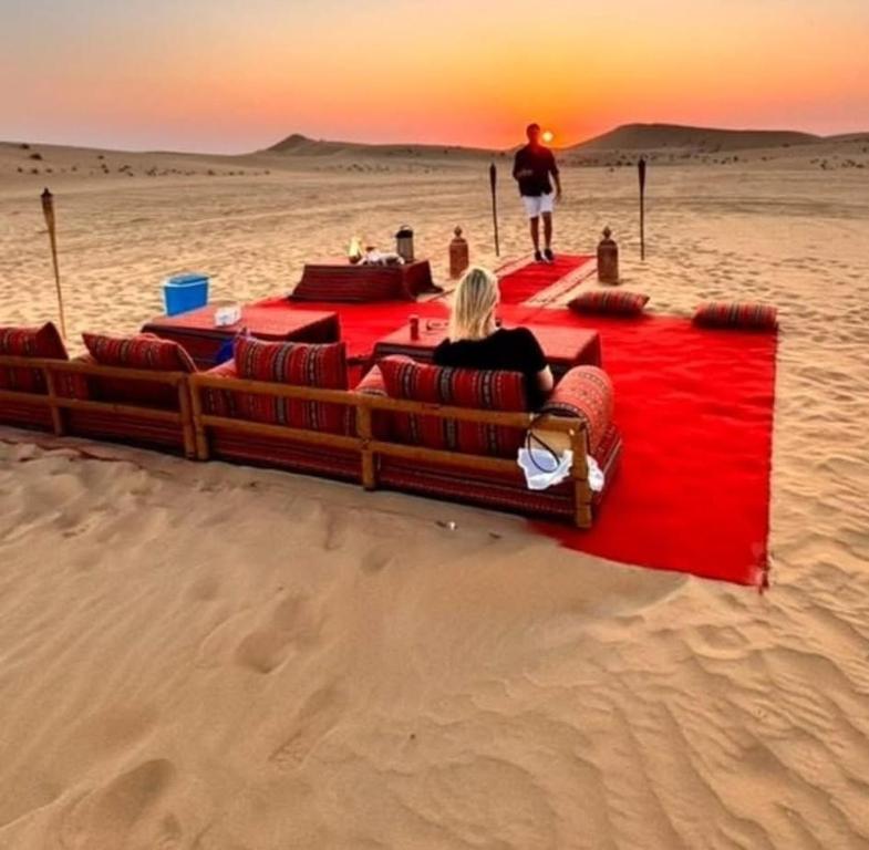 a woman sitting on a couch in the desert at The Majestic Heaven Resort in Sām