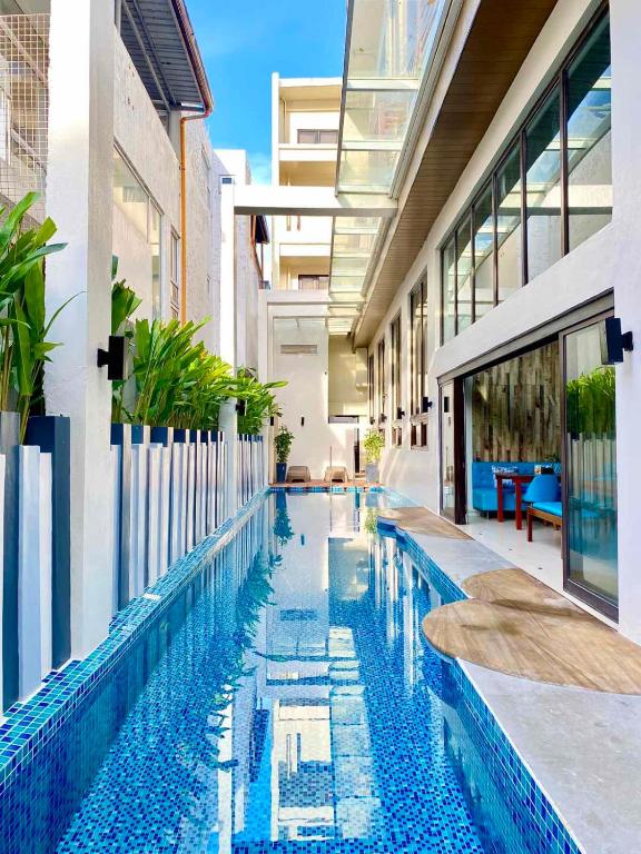 a swimming pool in the middle of a building at Ferra Premier by JG in Boracay