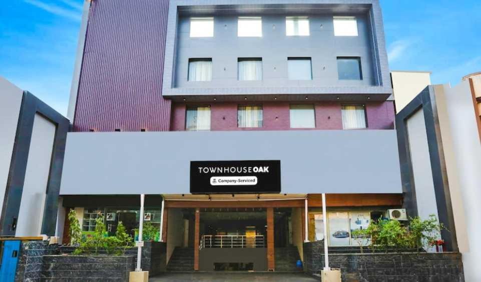a building with a sign on the front of it at Townhouse Oak CSJMU Kanpur Formerly Shree Dev Villa in Kaliānpur